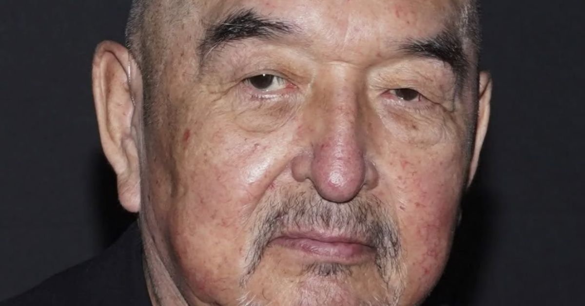 Oscar-nominated actor Graham Greene performing on stage with microphone